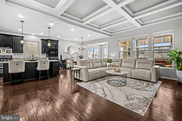 a living room with lots of furniture and view of kitchen