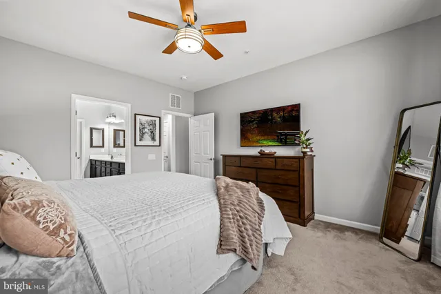 a bathroom with double vanity sinks a vanity and a large mirror