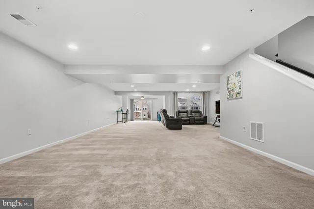 a view of a livingroom with furniture and a ceiling fan