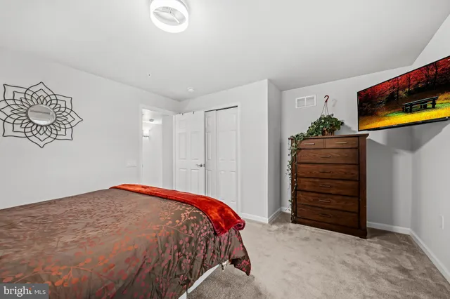 a view of a big house with a yard and plants