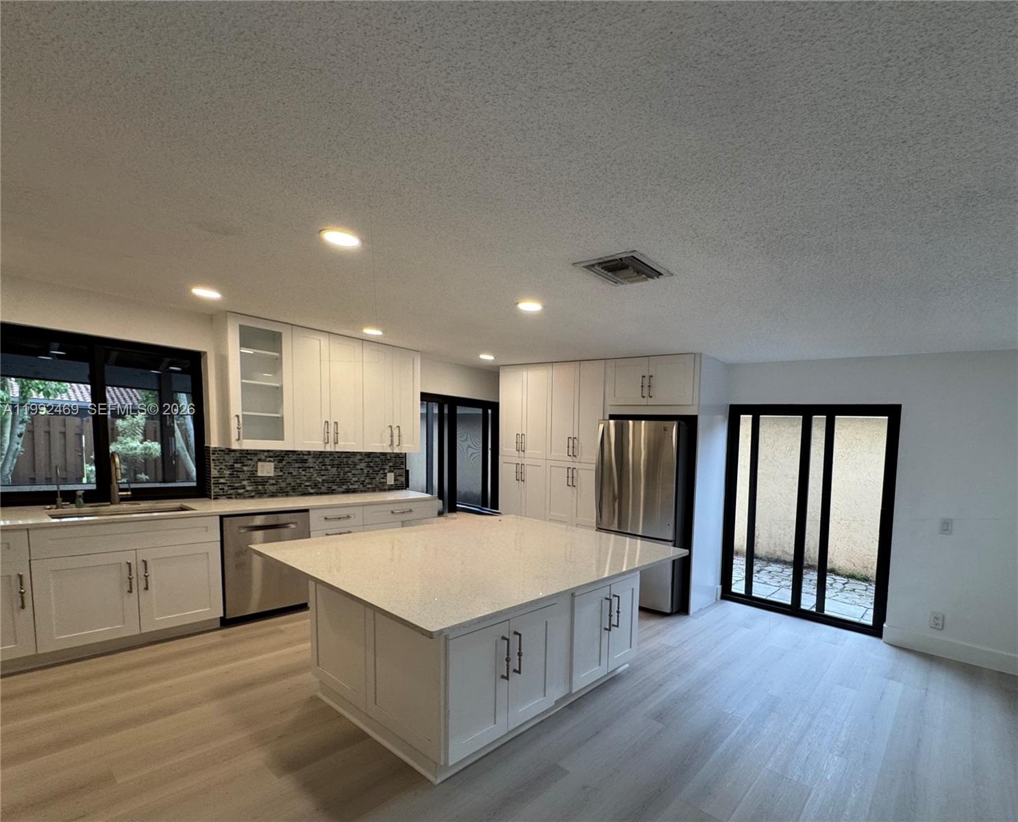 2159 Baton Rouge, Unit 2159 Weston, FL 33326 - Photo 17 of 49 a large kitchen with a stove a sink dishwasher a refrigerator and wooden floor