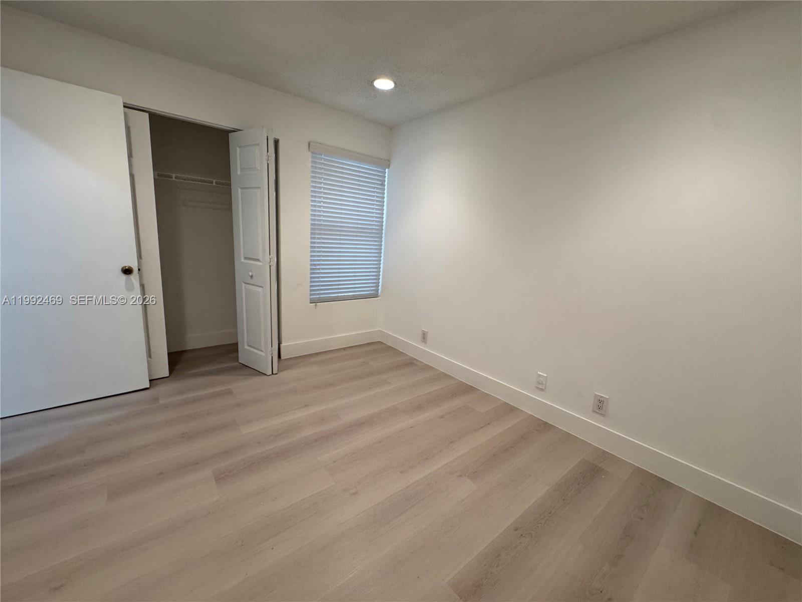 2159 Baton Rouge, Unit 2159 Weston, FL 33326 - Photo 36 of 49 an empty room with wooden floor and windows