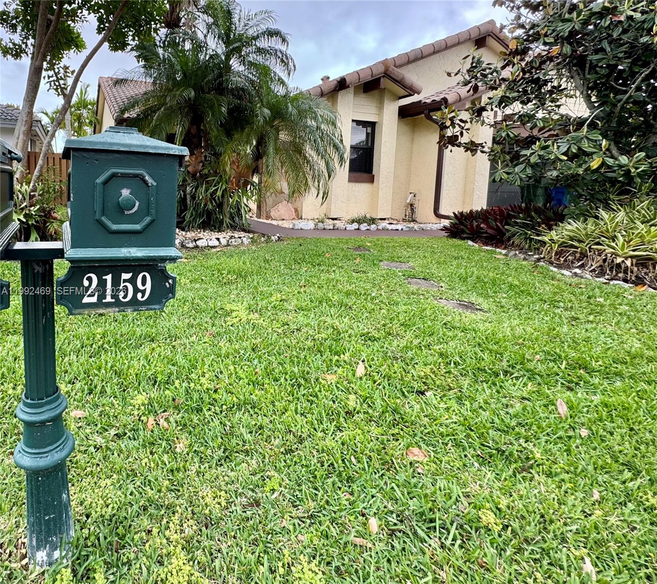 2159 Baton Rouge, Unit 2159 Weston, FL 33326 - Photo 6 of 49 a sign that is sitting in front of a house with plants
