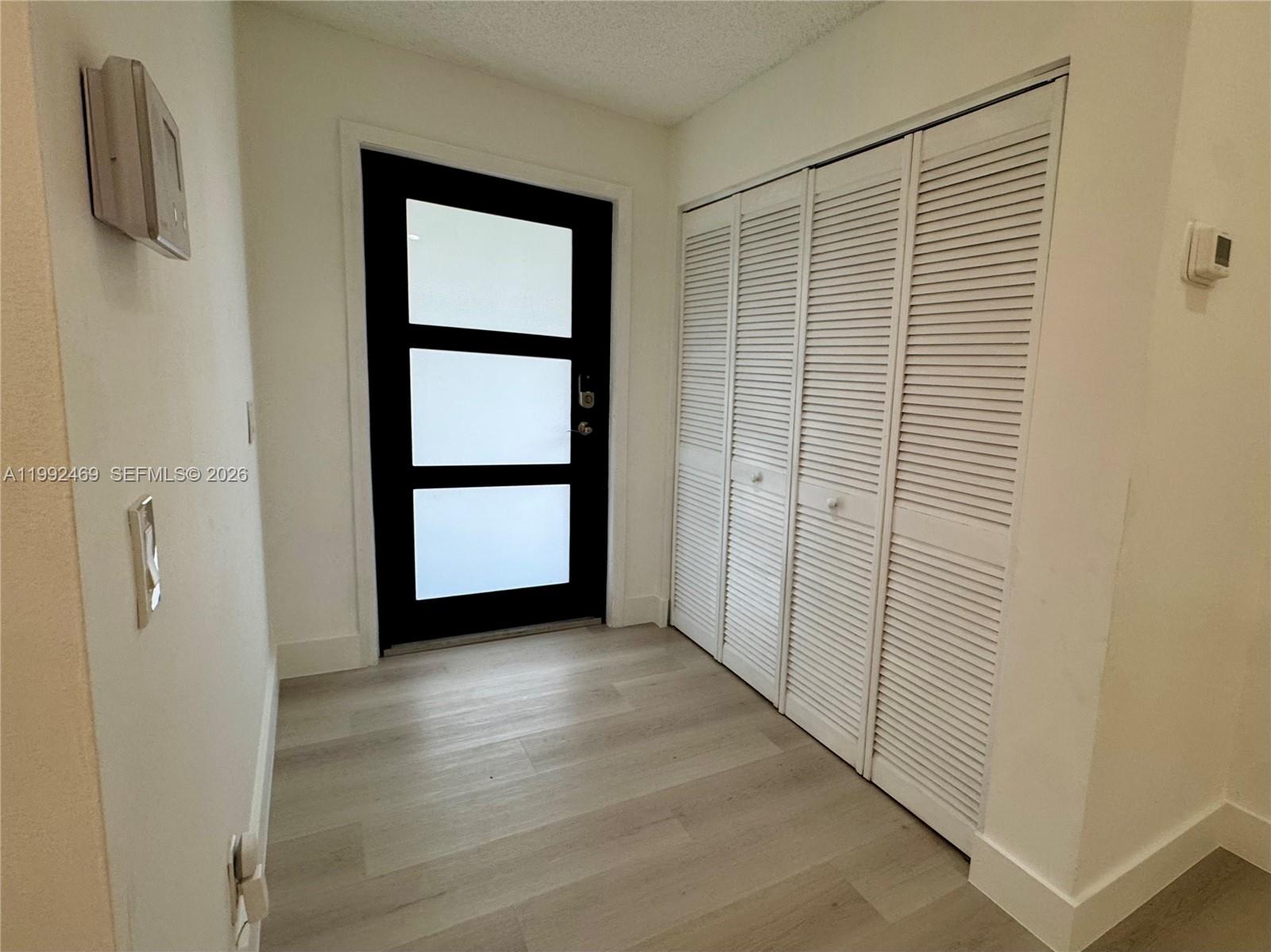 2159 Baton Rouge, Unit 2159 Weston, FL 33326 - Photo 9 of 49 a view of an empty room with wooden floor and a window