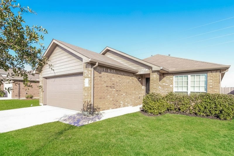 58 Santa Barbara Drive Manvel, TX 77578 - Photo 2 of 12 a view of a house with a small yard and a large tree