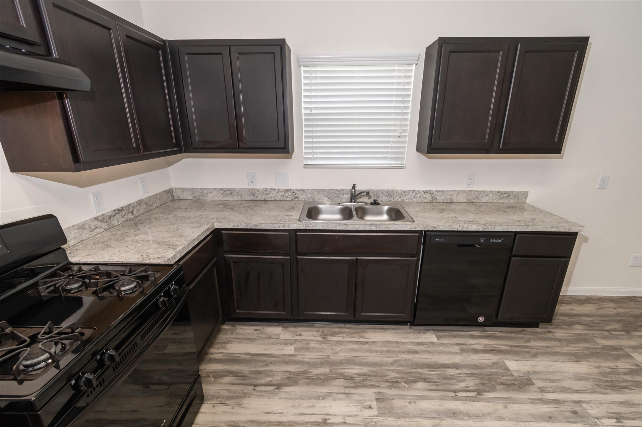 58 Santa Barbara Drive Manvel, TX 77578 - Photo 5 of 12 a kitchen with granite countertop a stove and a sink