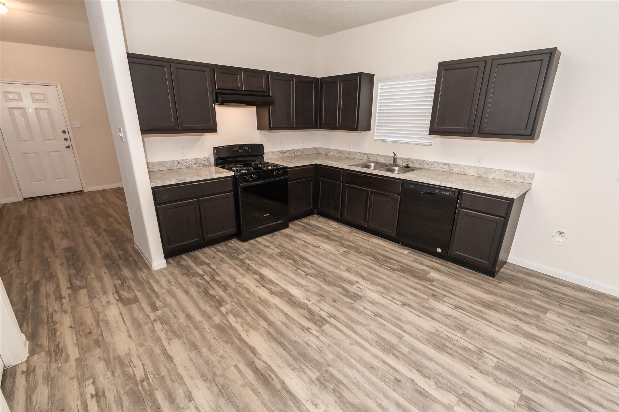 58 Santa Barbara Drive Manvel, TX 77578 - Photo 6 of 12 a kitchen with granite countertop a sink cabinets and wooden floor