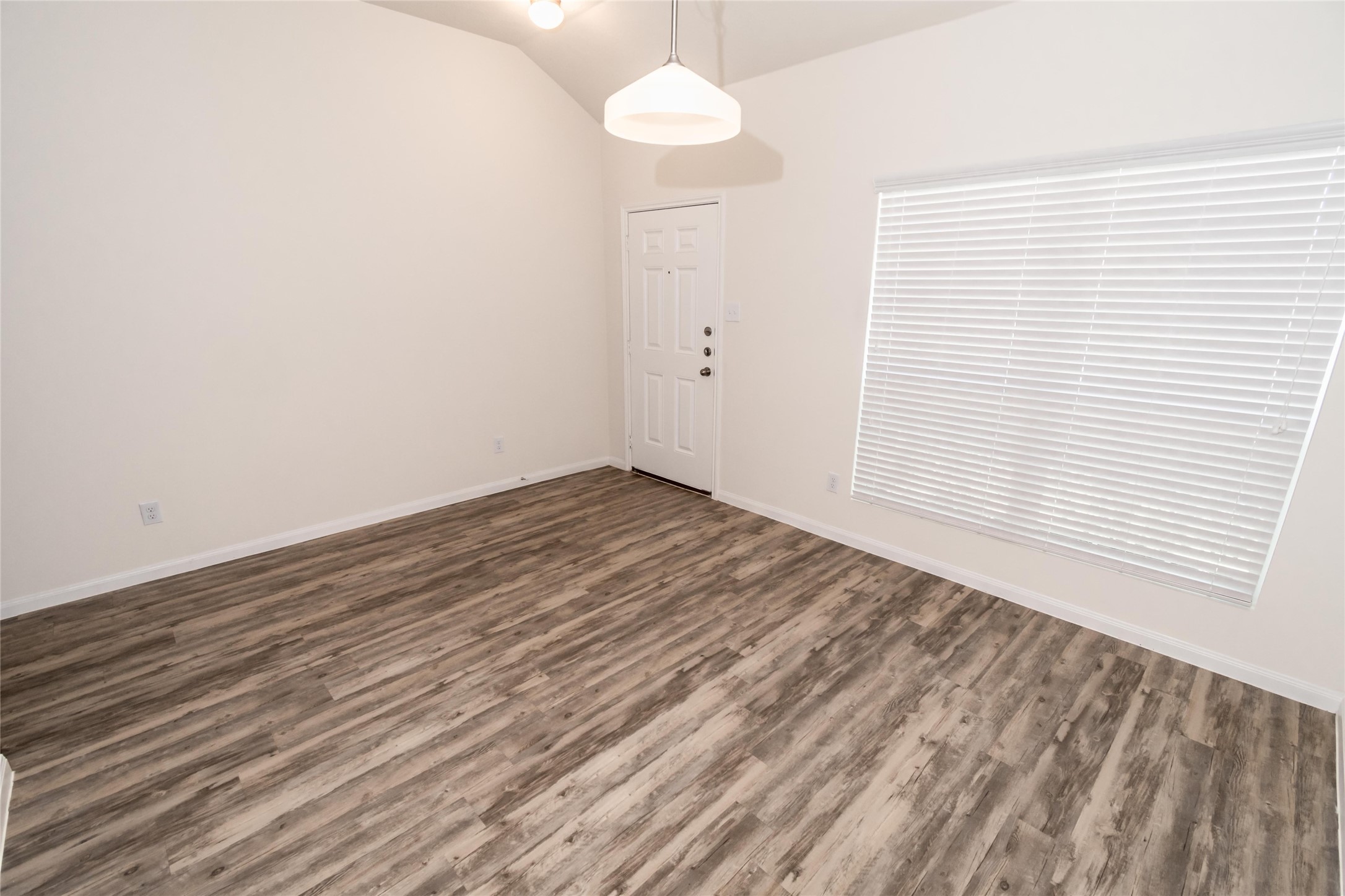 58 Santa Barbara Drive Manvel, TX 77578 - Photo 8 of 12 an empty room with wooden floor and windows