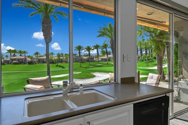 a view of a room with a large window and table