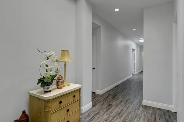 a bedroom with a bed couch and a larger window