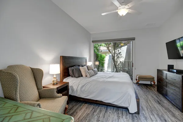 a bedroom with a bed and a flat screen tv