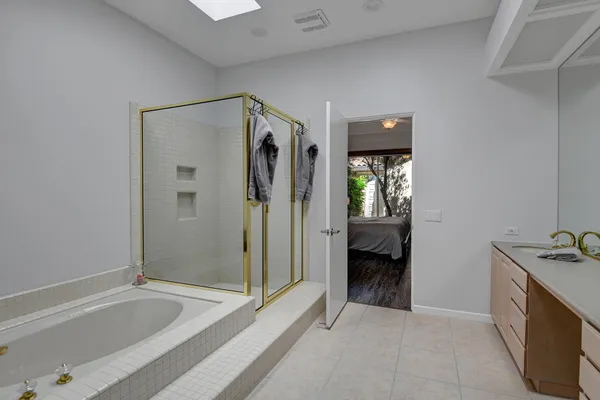 a spacious bathroom with a double vanity sink double and mirror