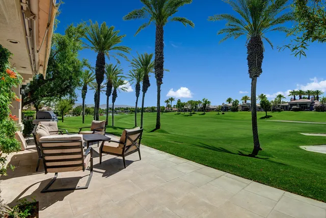 a view of a table and chairs in patio and a yard
