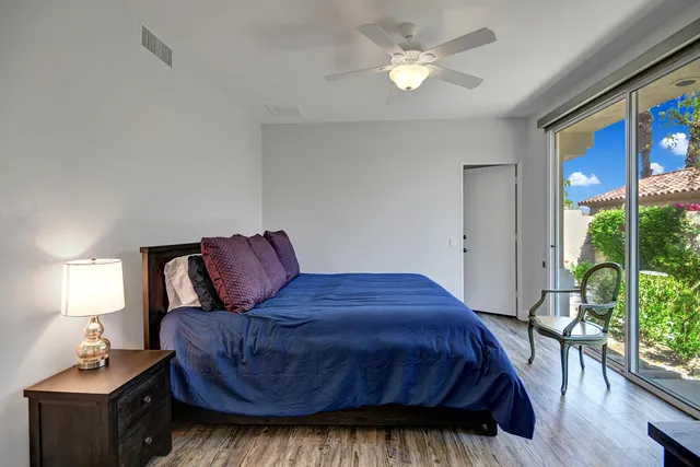 a bed room with a bed window and a television