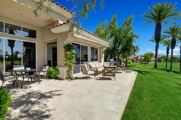 a view of a patio with table and chairs and potted plants