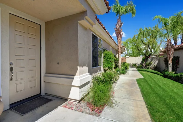 a front view of a house with garden and a sitting area