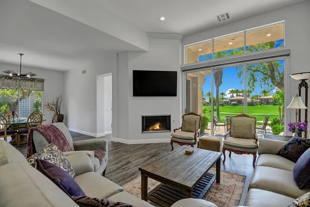 a living room with furniture fireplace and a flat screen tv