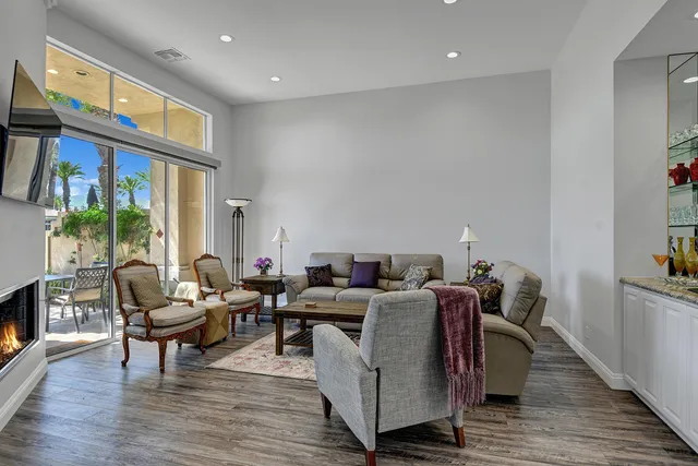 a living room with furniture wooden floor and a fireplace