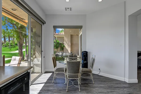 a dining room with furniture and wooden floor
