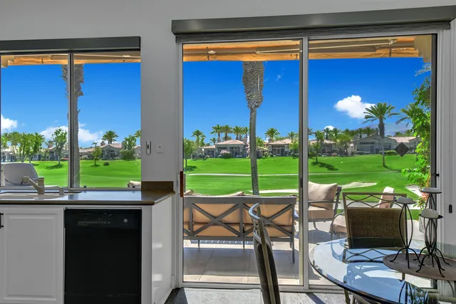 a view of a patio with a table and chairs