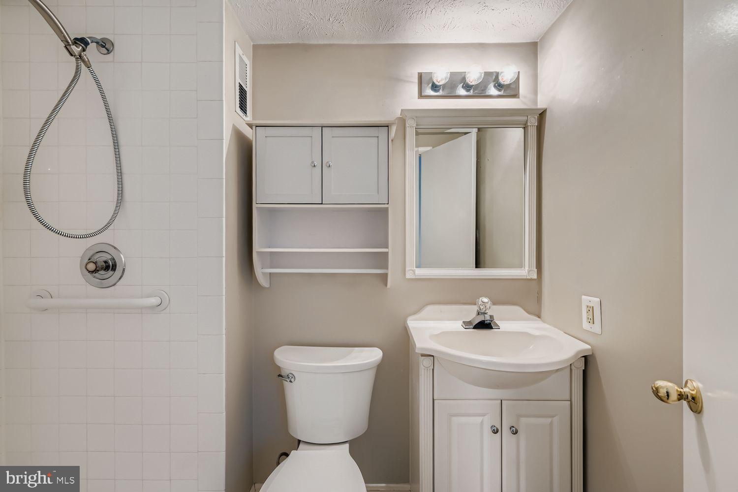 15604 Wembrough Street Silver Spring, MD 20905 - Photo 14 of 33 Modern bathroom with sleek fixtures.