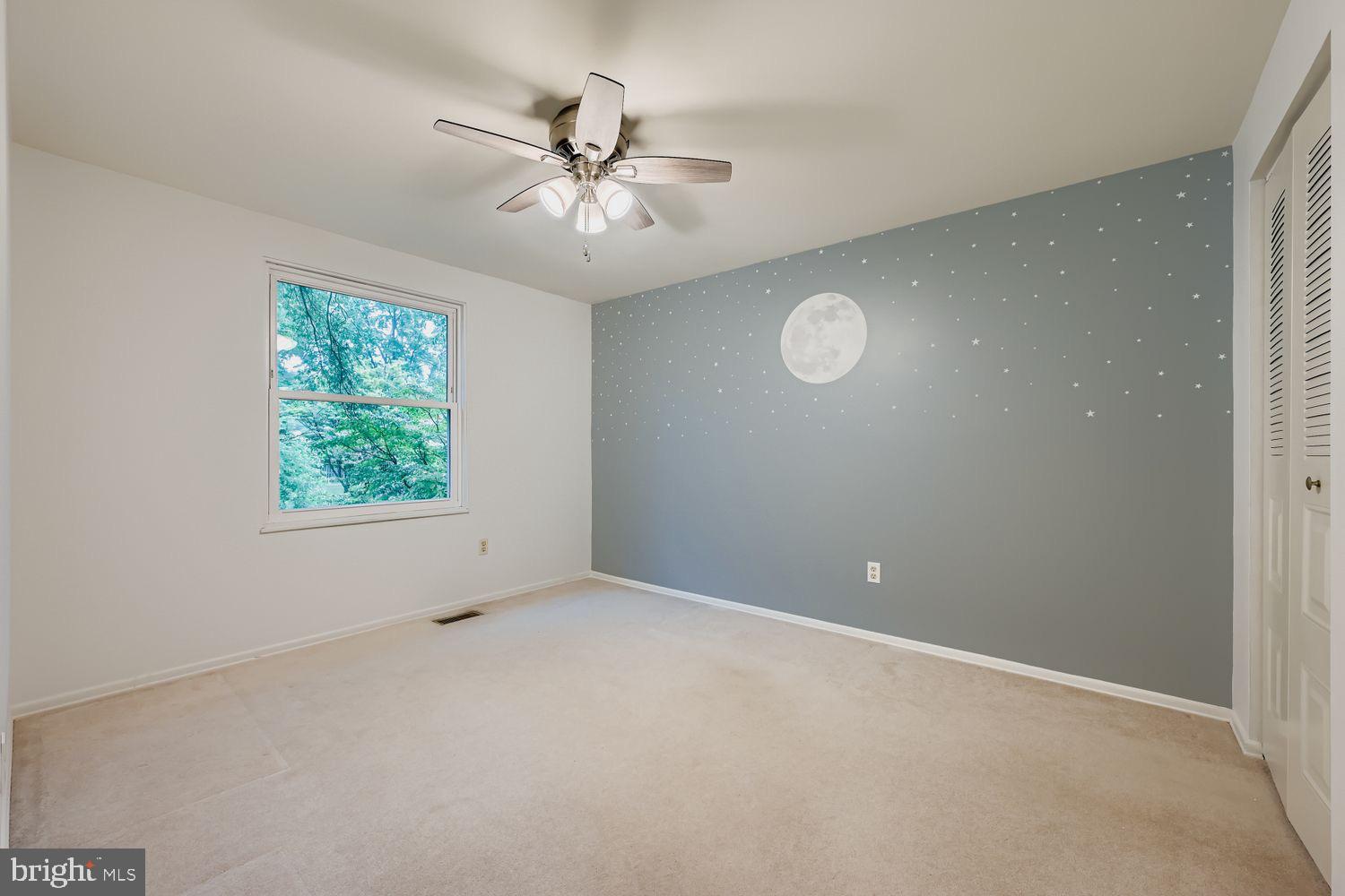 15604 Wembrough Street Silver Spring, MD 20905 - Photo 19 of 33 Serene room with moonlit wall design.