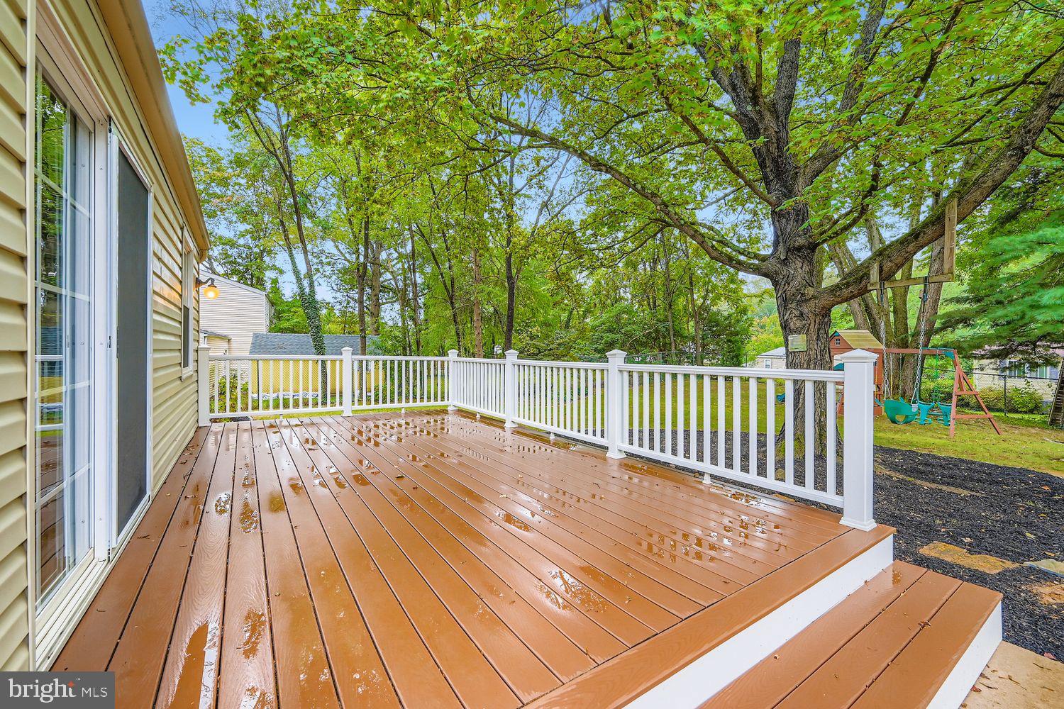 15604 Wembrough Street Silver Spring, MD 20905 - Photo 26 of 33 Serene deck surrounded by lush greenery.