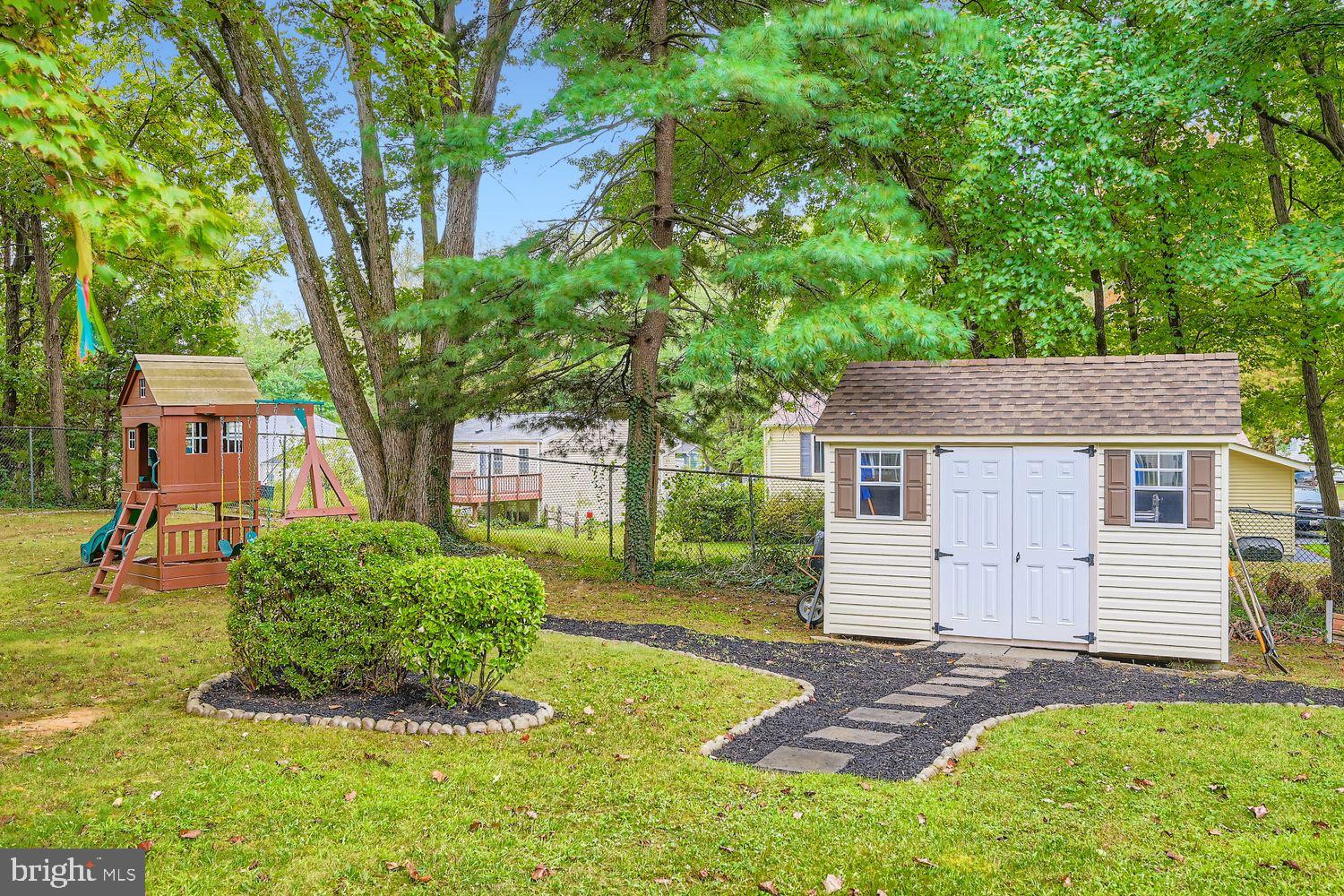 15604 Wembrough Street Silver Spring, MD 20905 - Photo 32 of 33 Charming backyard with playset and shed.