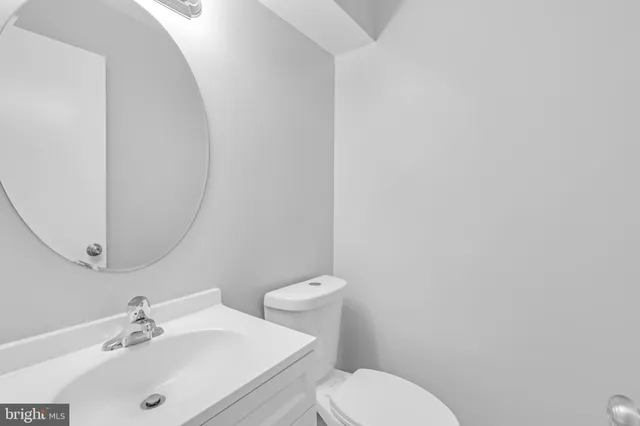 a bathroom with a sink mirror and toilet