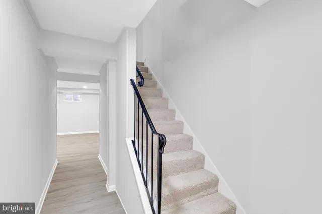 a view of a hallway with wooden floor and entryway