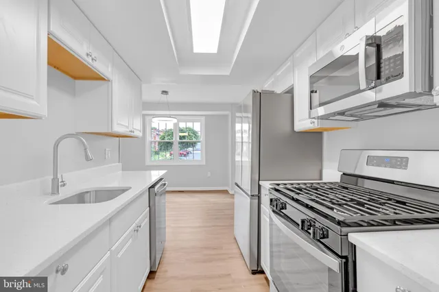 a kitchen that has a sink and a stove
