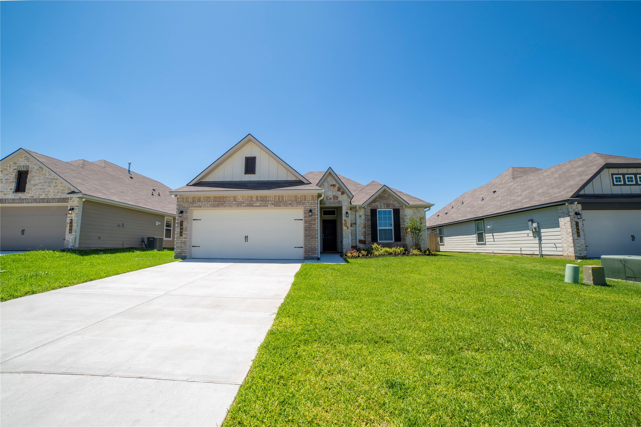 1402 Lk Rdg Drive Brenham, TX 77833 - Photo 1 of 35 a front view of a house with a yard and garage