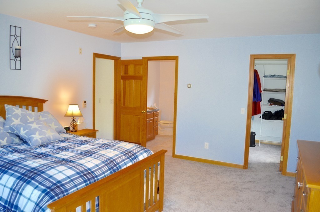 66 Zuell Hill Road Monson, MA 01057 - Photo 15 of 25 a bedroom with a bed and a lamp