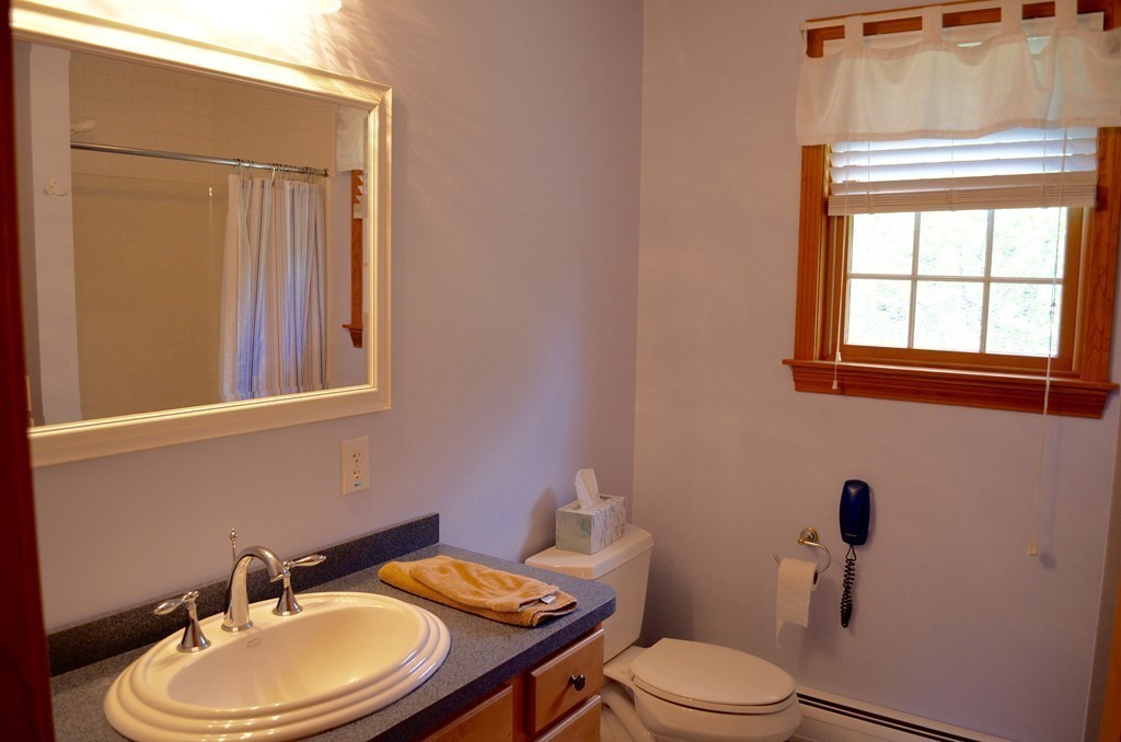 66 Zuell Hill Road Monson, MA 01057 - Photo 17 of 25 a bathroom with a sink a toilet and a mirror