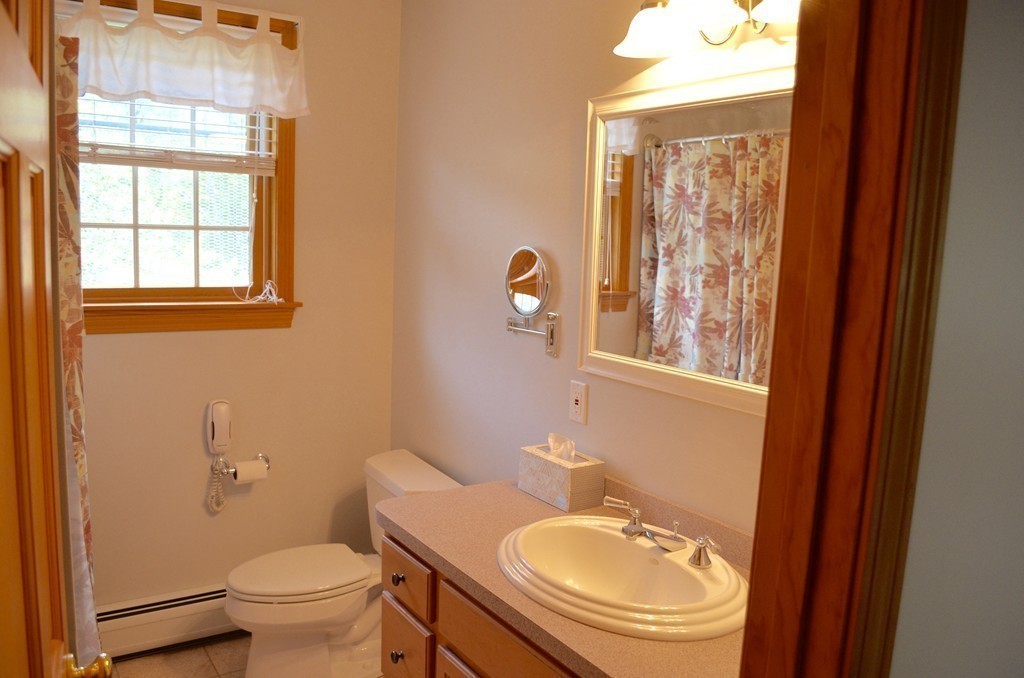 66 Zuell Hill Road Monson, MA 01057 - Photo 18 of 25 a bathroom with a sink a toilet and a window