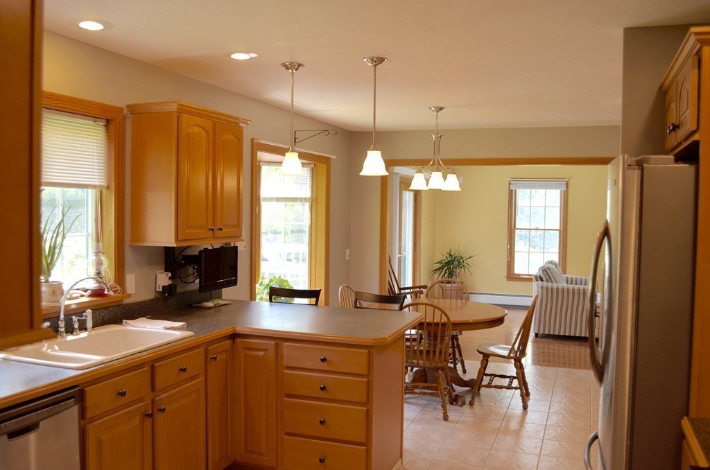66 Zuell Hill Road Monson, MA 01057 - Photo 8 of 25 a kitchen with a table chairs refrigerator and sink