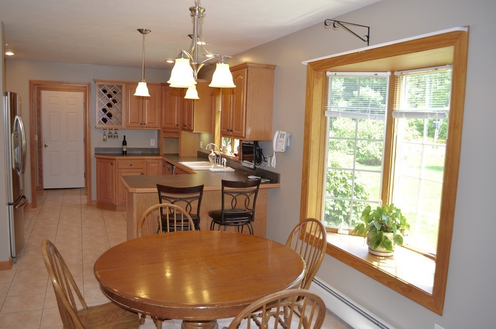 66 Zuell Hill Road Monson, MA 01057 - Photo 9 of 25 a dining room with furniture window and wooden floor