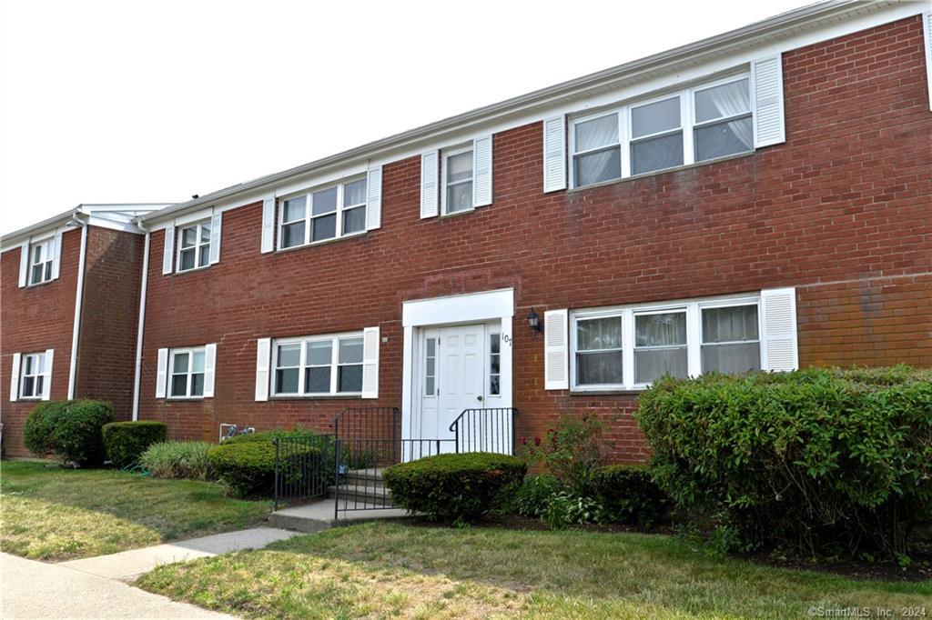 a front view of a house having yard and green space