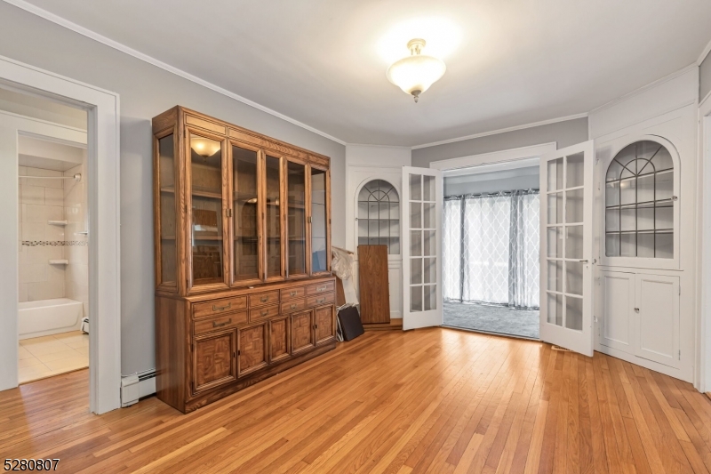153 Stirling Road Watchung, NJ 07069 - Photo 23 of 31 wooden floor chandelier and windows in a room