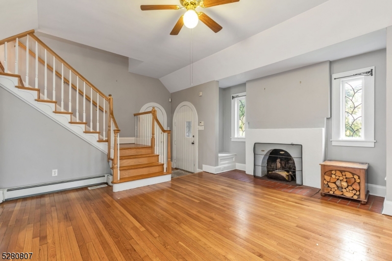 153 Stirling Road Watchung, NJ 07069 - Photo 24 of 31 a view of a livingroom with furniture a fireplace wooden floor and windows