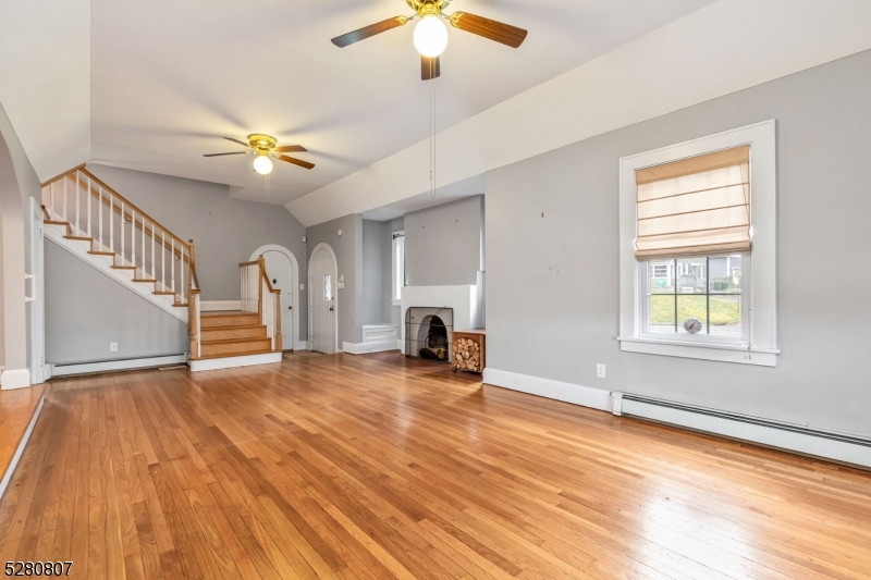153 Stirling Road Watchung, NJ 07069 - Photo 25 of 31 wooden floor in an empty room with a window and a kitchen