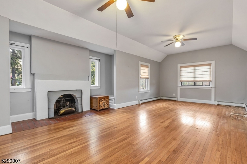153 Stirling Road Watchung, NJ 07069 - Photo 26 of 31 a view of empty room with fireplace and wooden floor