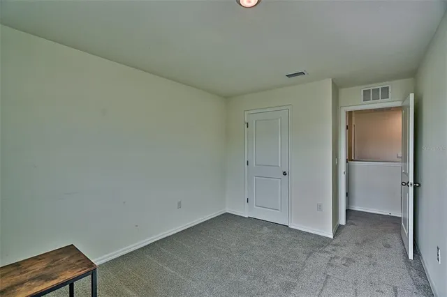 a view of a room with window and hardwood floor