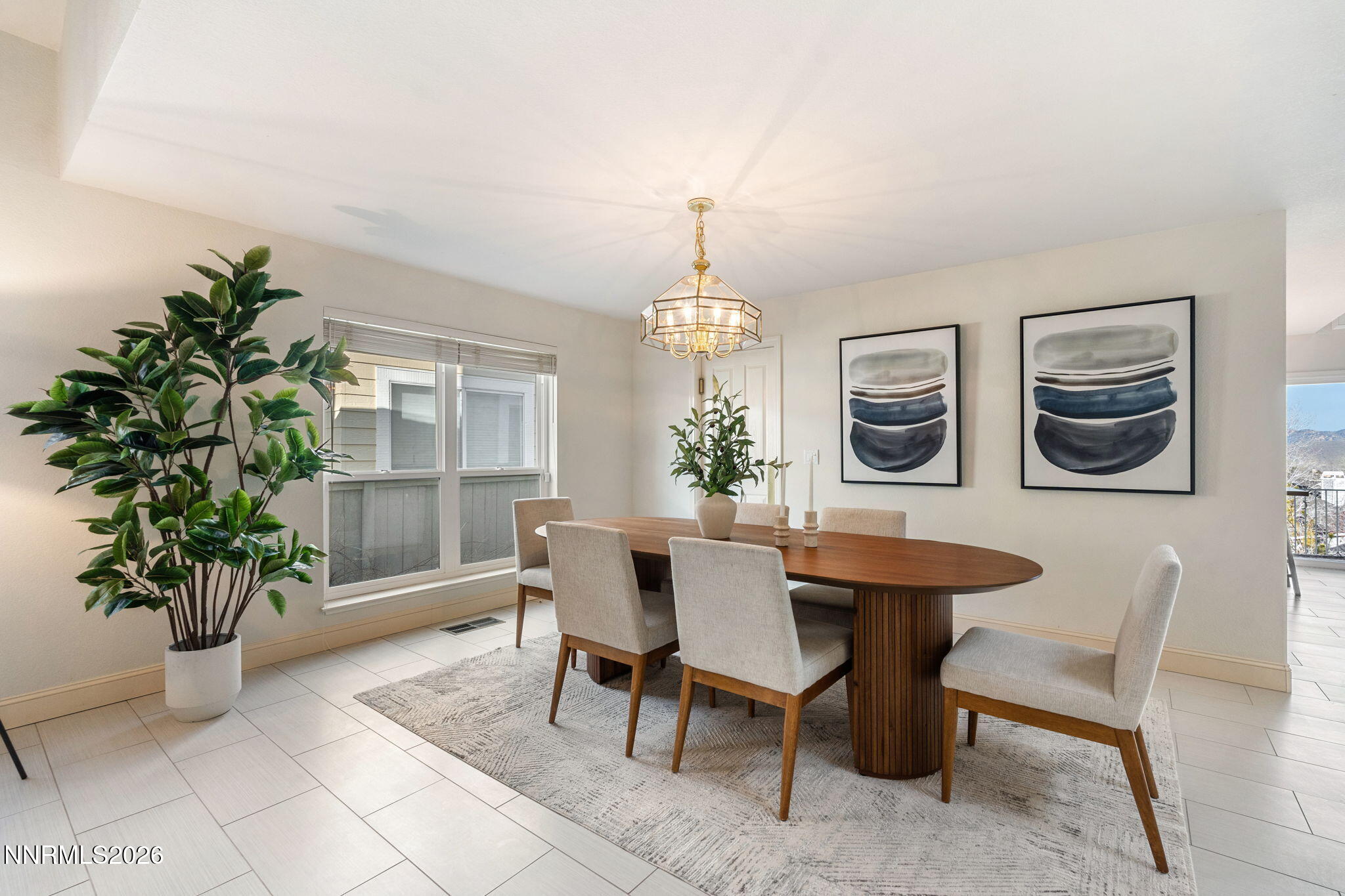 6186 Squires Lane Reno, NV 89519 - Photo 9 of 57 a dining room with furniture potted plants and wooden floor
