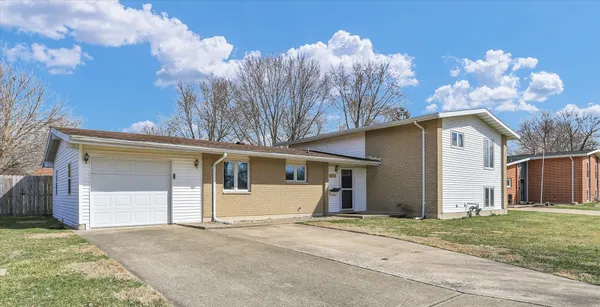 a view of a house with a yard and garage