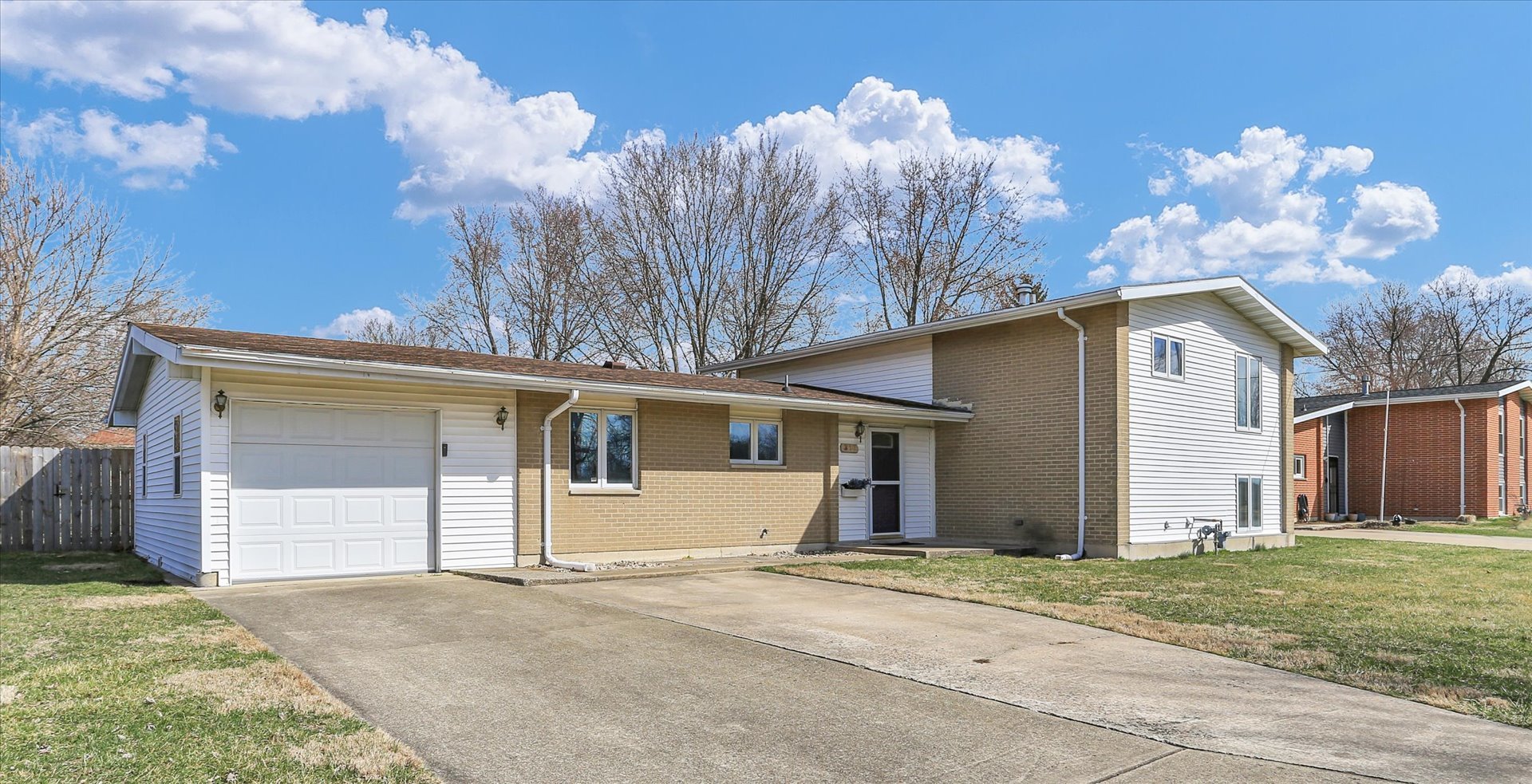 a view of a house with a yard and garage
