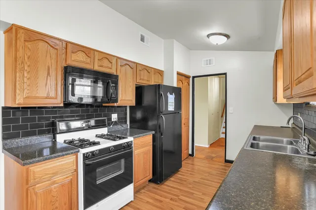 a kitchen with a sink stove and refrigerator