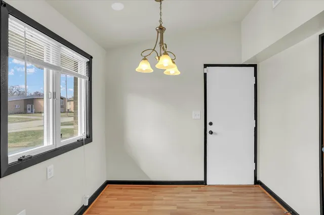 a view of a room with wooden floor and windows