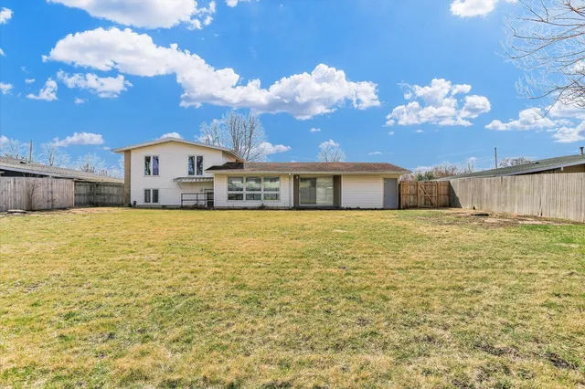 a front view of a house with a big yard