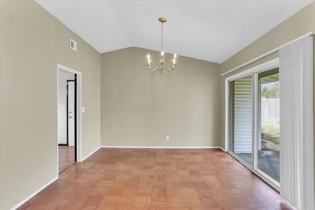 a view of a chandelier in big room and chandelier
